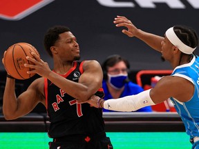 Kyle Lowry, left, of the Toronto Raptors is defended by Devonte' Graham of the Charlotte Hornets during a game  at Amalie Arena on Jan. 16, 2021 in Tampa, Florida.
