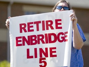 A woman takes part in a protest against the Enbridge Line 5 pipeline in a file photo from Holt, Mich., in July 2017.