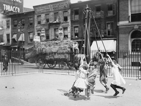 Children play on a giant stride in a New York City playground in this photograph taken just before the First World War.