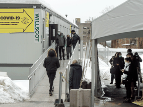 People line up to get tested at a COVID-19 clinic this week in Montreal. There is growing skepticism that a third wave is inevitable for Canada.