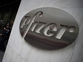 This file photo taken on April 27, 2016 shows the Pfizer company logo on the wall in front of Pfizers headquarters in New York. - North Korean hackers tried to break into the computer systems of pharmaceutical giant Pfizer in a search for information on a coronavirus vaccine and treatment technology, South Korea's spy agency said on February 16, 2021, according to reports.