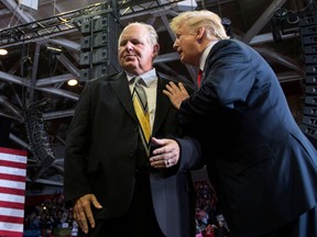 Then-President Donald Trump speaks to radio talk show host Rush Limbaugh at a Make America Great Again rally in Cape Girardeau, Missouri in 2018.