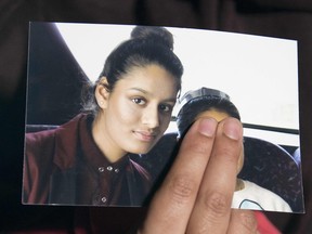 In this file photo taken on February 22, 2015 Renu, eldest sister of missing British girl Shamima Begum, holds a picture of her sister while being interviewed by the media in central London, on February 22, 2015.