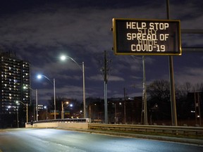 A highway sign encouraging people to stay home in Toronto, Ontario, Canada, on Monday, Nov. 23, 2020.