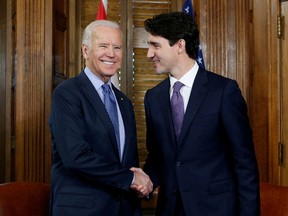 Canada's prime minister, Justin Trudeau (R), shakes hands with then-U.S. Vice President Joe Biden during a meeting in Trudeau's office on Parliament Hill in Ottawa, Ontario, Canada, December 9, 2016.