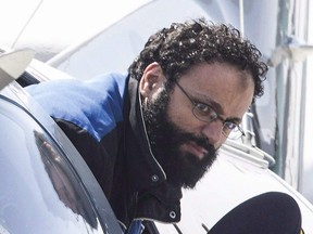 Chiheb Esseghaier is led off a plane by an RCMP officer at Buttonville Airport just north of Toronto on April 23, 2013.