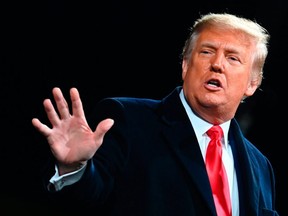 In this photo taken on December 5, 2020, former U.S. President Donald Trump gestures as he speaks at a rally to support Republican Senate candidates at Valdosta Regional Airport in Valdosta, Georgia.