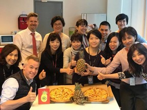 Officials at the Canadian Trade Office in Taipei posing with pineapples and Hawaiian pizza after China banned imports of the fruit from Taiwan. Picture was posted March 2, 2021.