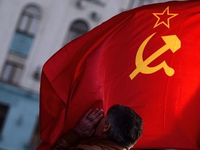 A man kisses the Soviet Union flag in Simferopol's Lenin Square on March 16, 2014.