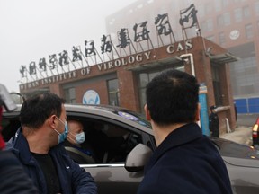 Members of the World Health Organization (WHO) team investigating the origins of the COVID-19 coronavirus arrive by car at the Wuhan Institute of Virology in Wuhan in China's central Hubei province on February 3, 2021.