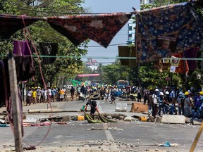 Protesters seem able to hold back forces by hanging sarongs over clotheslines across the streets.