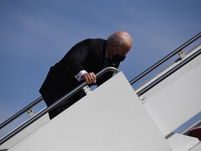 U.S. President Joe Biden stumbles as he boards Air Force One at Joint Base Andrews in Maryland on March 19, 2021.