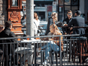 People sit at a restaurant patio to take advantage of sunny weather in Ottawa, March 20, 2021.
