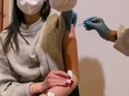 A young woman is vaccinated with the Pfizer-BioNTech vaccine on March 11, 2021 in Schwaz, Austria.