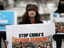 People rally to encourage Canada and other countries to label China's treatment of its Uighur population and Muslim minorities as genocide, outside the Canadian Embassy in Washington, D.C., February 19, 2021.