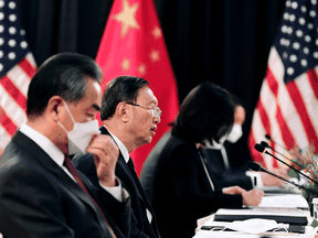 The Chinese delegation led by Yang Jiechi, centre, and Wang Yi, left, speak with their U.S. counterparts at the opening session of U.S.-China talks in Anchorage, Alaska on March 18, 2021.