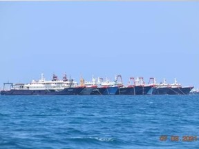 Some of the about 220 Chinese vessels reported by the Philippine Coast Guard, and believed to be manned by Chinese maritime militia personnel, are pictured at Whitsun Reef, South China Sea, March 7, 2021.