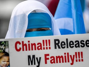 Uyghur women from East Turkestan demonstrate to ask for news of relatives and to express their concern about the ratification of an extradition treaty between China and Turkey, near the Chinese consulate in Istanbul on March 8, 2021, during International Women's Day.