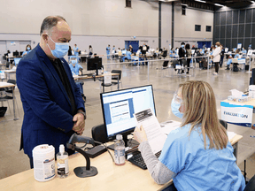 Quebec Health Minister Christian Dubé is evaluated before receiving the AstraZeneca COVID-19 vaccine at a COVID-19 vaccination clinic in Montreal, Thursday, March 18, 2021.