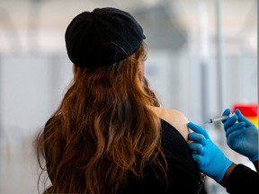 Siem Tran, dental assistant, receives a dose of the Moderna coronavirus vaccine as part of the COVID-19 vaccination campaign, in Brampton, Ontario, March 4, 2021.