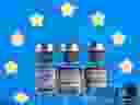 Vials with Pfizer-BioNTech, AstraZeneca, and Moderna coronavirus disease (COVID-19) vaccine labels are seen in front of a European Union (EU) flag in this illustration picture taken March 19, 2021.