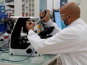 A lab researcher works at the vaccine unit of French drugmaker Sanofi's Pasteur plant near Lyon on June 16, 2020.