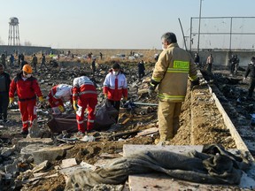 Rescue workers recover a body from the wreckage of Ukraine International Airlines Flight 752, which crashed shortly after takeoff in Iran, on Wednesday, Jan. 8, 2020.