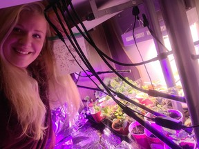 Lyanne Betit in her indoor laboratory with the plants that she grew in the Instant Pot.