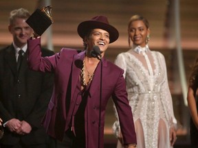 In this Feb. 15, 2016 file photo, Bruno Mars accepts the award for record of the year for "Uptown Funk" at the 58th annual Grammy Awards in Los Angeles.