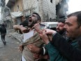 A father reacts after the death of two of his children, whom activists said were killed by shelling by forces loyal to Syrian President Bashar Assad, in a file photo from Jan. 3, 2013, in Aleppo, Syria