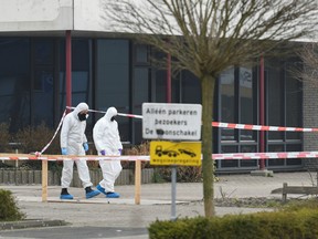 Forensic officers investigate the area at the scene of an explosion at a COVID-19 testing location in Bovenkarspel, near Amsterdam, Netherlands March 3, 2021.