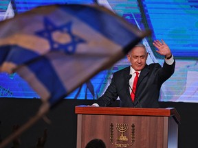 Israeli Prime Minister Benjamin Netanyahu, leader of the Likud party, waves to supporters at the party campaign headquarters in Jerusalem early on March 24, 2021, after the end of voting in the fourth national election in two years.