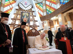 Pope Francis, second from right, meets with with bishops, priests, seminarians and catechists at the Syro-Catholic Cathedral of Our Lady of Salvation, in Baghdad on March 5.