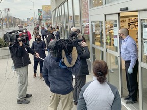 The line for AstraZeneca's COVID-19 vaccine forms before 8 a.m. Thursday outside the Shoppers Drug Mart at Danforth and Coxwell avenues in East End  Toronto.