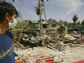 A Thai rescue worker looks at the hotels and stores destroyed by tsunami in 2004.