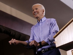 Joe Biden, then still a presidential candidate,  rolls up his sleeves as he prepares to address union workers at the Teamsters Local 249 hall in Pittsburgh on April 29, 2019.