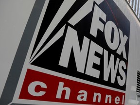 A Fox News channel sign  on a television vehicle outside the News Corporation building in New York City