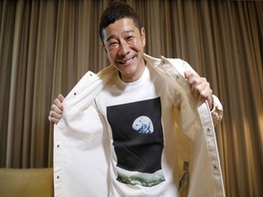 Japanese billionaire Yusaku Maezawa is photographed wearing his T-shirt with an image of Earth during an interview for Reuters in Tokyo.