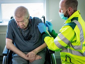Aage Steen Jensen, a 67-year-old  kidney patient, is vaccinated in his own home in Aalborg, Denmark on March 5, 2021.