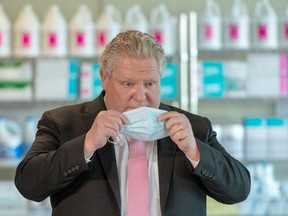 Ontario Premier Doug Ford puts his mask back on after speaking in his daily briefing at Rouge Valley Hospital in Toronto on Monday, March 22, 2021.