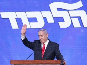 Benjamin Netanyahu, Israel's prime minister and the leader of the Likud party, waves to his supporters on stage during a party event in Jerusalem, Israel, on Wednesday, March 24, 2021.