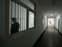 A guard looks through a window inside a detention centre in Beijing.