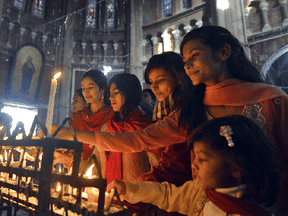 Pakistani Christians attend Christmas Day prayers at the Sacred Heart Cathedral Church in Lahore.