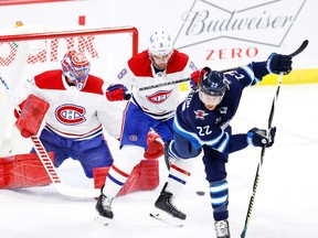 Montreal Canadiens goaltender Carey Price, left, and defenseman Ben Chiarot fend off Winnipeg Jets centre Mason Appleton in a February game.