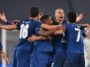 Sergio Oliveira of Porto celebrates with team mates after scoring their side's second goal during the UEFA Champions League Round of 16 match between Juventus and FC Porto at Juventus Arena on March 09, 2021 in Turin, Italy.
