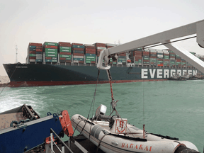 Egyptian tug boats try to free Taiwan-based cargo MV Ever Given (Evergreen), a 400-metre-long and 59-metre wide vessel, lodged sideways and impeding all traffic across the waterway of Egypt's Suez Canal.