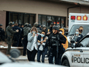 Healthcare workers walk out of a King Sooper's Grocery store after a gunman opened fire on March 22 in Boulder, Colorado.