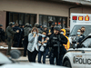 Healthcare workers walk out of a King Sooper’s Grocery store after a gunman opened fire on March 22, 2021 in Boulder, Colorado.