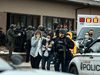 Healthcare workers walk out of a King Sooper's Grocery store after a gunman opened fire on March 22 in Boulder, Colorado.