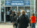 People line up at a COVID-19 vaccination centre in London, Ont. 